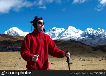 Hiker on the road in Himalayas with mountains landscape
