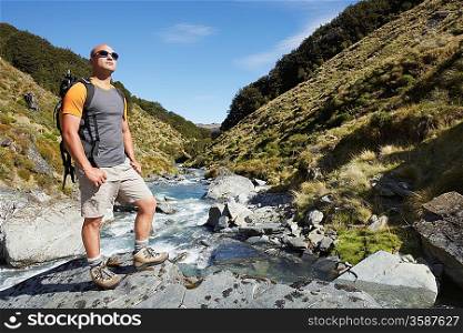 Hiker standing by edge of river