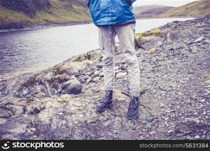 Hiker standing by Loch in Scotland