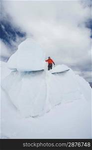 Hiker standing on top ice formation