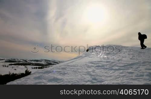 hiker standing on top of mountain
