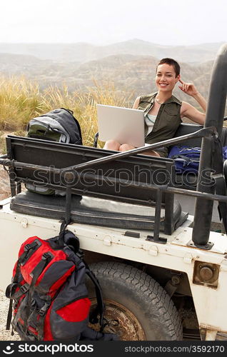 Hiker Using Laptop in Land Rover