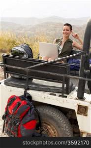 Hiker Using Laptop in Land Rover