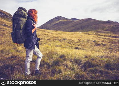 Hiker with backpack walking in the mountains