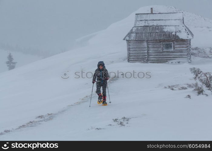 Hiker with snowshoes in winter