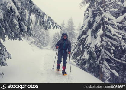 Hiker with snowshoes in winter