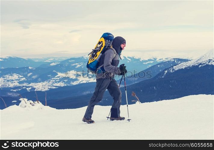 Hiker with snowshoes in winter