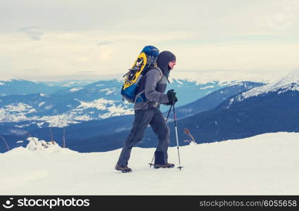 Hiker with snowshoes in winter