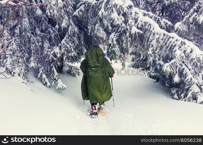 Hiker with snowshoes in winter