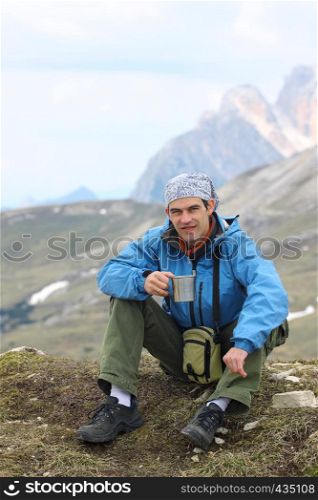 hiker with the high rocky mountains at the background