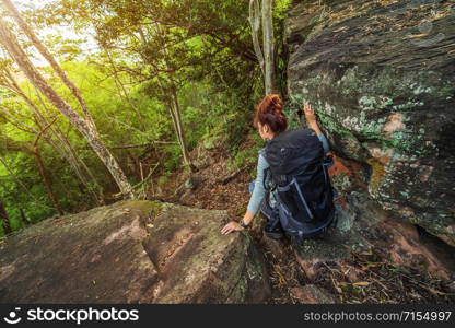 hiker woman climbing down in the forest