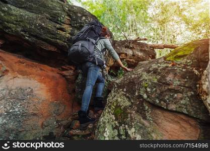 hiker woman climbing up in the forest