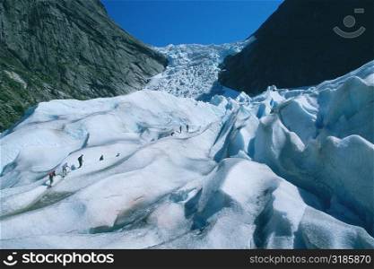 Hikers climbing a mountain, Briksdalsbreen Glacier, Norway
