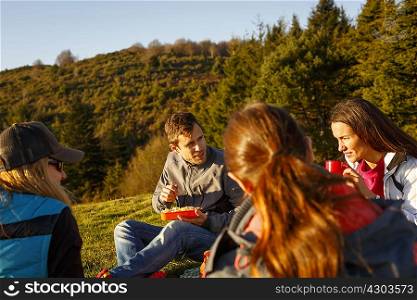 Hikers having picnic on hilltop, Montseny, Barcelona, Catalonia, Spain