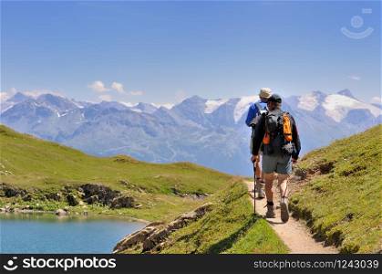 hikers walking on a path in mountain