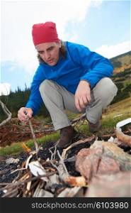 hiking adventure, hiking man try to light fire, collecting woods for fire