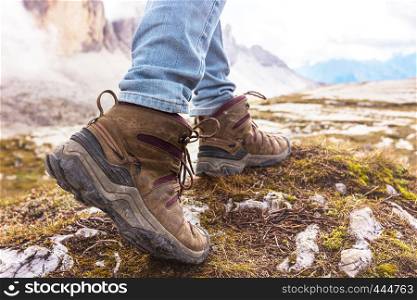hiking boots close-up. tourist walking on the trail. Dolomites, Italy