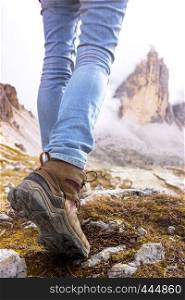 hiking boots close-up. tourist walking on the trail. Dolomites, Italy