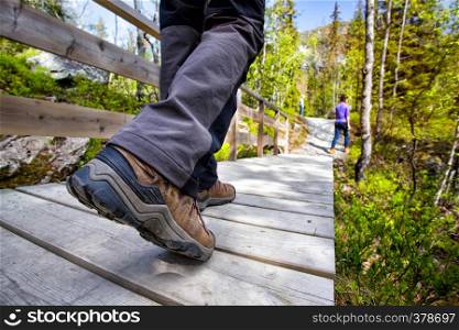 hiking boots close-up. tourist walking on the trail. Norway