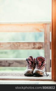 Hiking boots on rustic wood floor in an abandoned mountain chalet in Austria