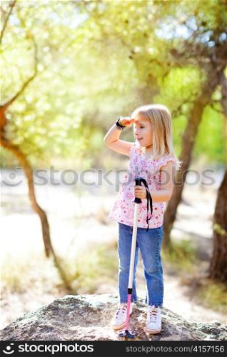 hiking kid girl searching hand in head in forest outdoor