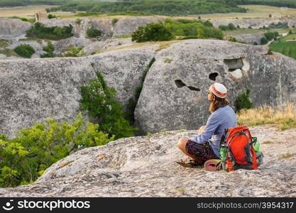 Hiking man having rest at the top of Eski Kermen, Crimea, Ukraine