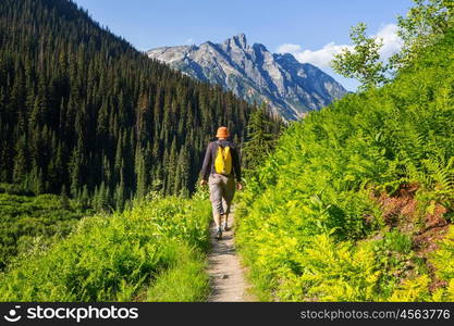 Hiking man in Canadian mountains. Hike is the popular recreation activity in North America. There are a lot of picturesque trails.