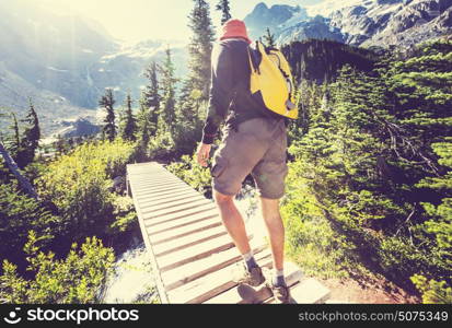 Hiking man in Canadian mountains. Hike is the popular recreation activity in North America. There are a lot of picturesque trails.