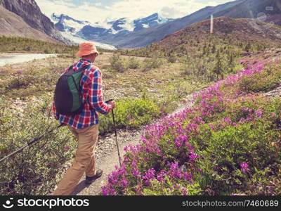 Hiking man in Canadian mountains. Hike is the popular recreation activity in North America. There are a lot of picturesque trails.