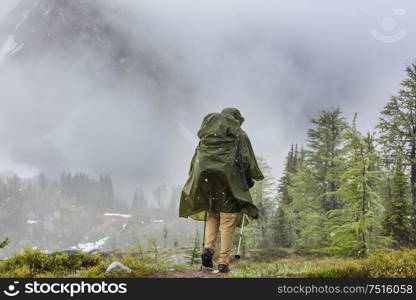 Hiking man in Canadian mountains. Hike is the popular recreation activity in North America. There are a lot of picturesque trails.