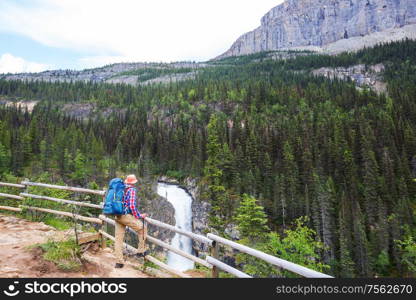 Hiking man in Canadian mountains. Hike is the popular recreation activity in North America. There are a lot of picturesque trails.