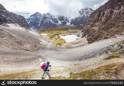 Hiking man in Canadian mountains. Hike is the popular recreation activity in North America. There are a lot of picturesque trails.