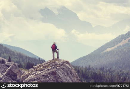 Hiking man in Canadian mountains. Hike is the popular recreation activity in North America. There are a lot of picturesque trails.