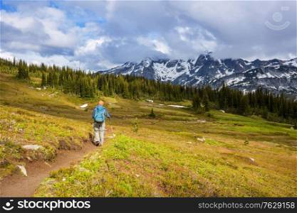 Hiking man in the mountains outdoor active lifestyle travel adventure vacations summertime. Hike concept