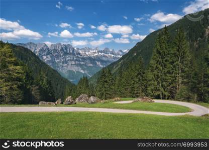 Hiking route through the Alps mountains, covered with green forests, in spring, in St. Gallen Canton, near Walensee lake, in Switzerland.
