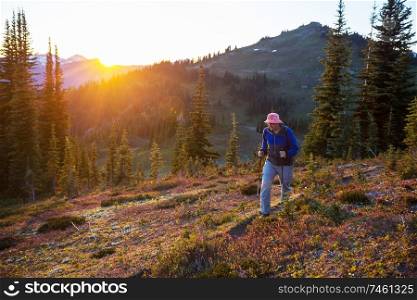 Hiking scene in beautiful summer mountains at sunset