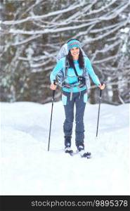 Hiking ski in the woods. A girl alone
