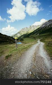 Hiking trail in the Austrian mountains, mountain range and blue sky