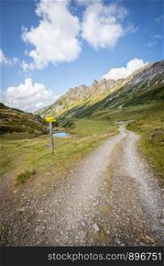 Hiking trail in the Austrian mountains, mountain range and blue sky