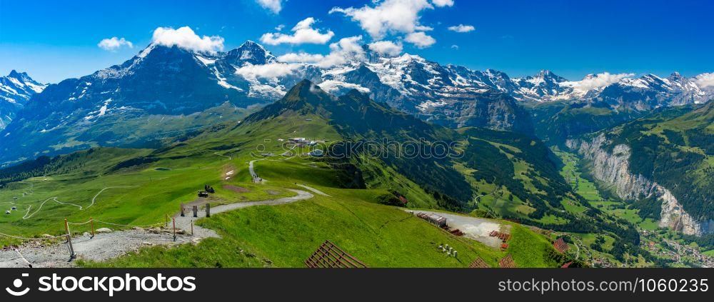 Hiking trail to summit of mountain Mannlichen, popular viewpoint in Swiss Alps, Switzerland. Eiger, Monch and Jungfrau, Lauterbrunnen in background.. Mountain Mannlichen, Switzerland