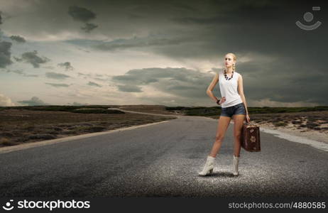 Hiking traveling. Young woman hiker standing with suitcase in hand