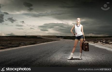 Hiking traveling. Young woman hiker standing with suitcase in hand