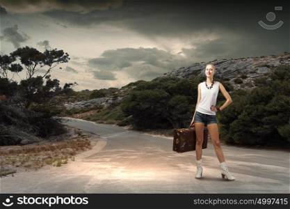 Hiking traveling. Young woman hiker standing with suitcase in hand