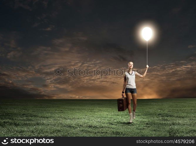 Hiking traveling. Young woman hiker walking with suitcase in hand