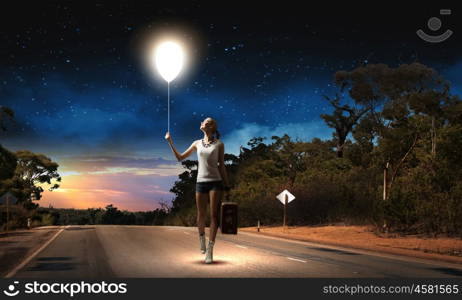 Hiking traveling. Young woman hiker walking with suitcase in hand