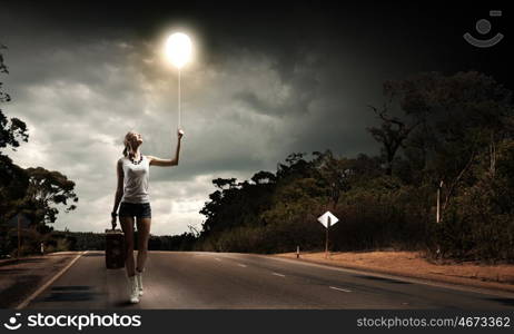 Hiking traveling. Young woman hiker walking with suitcase in hand