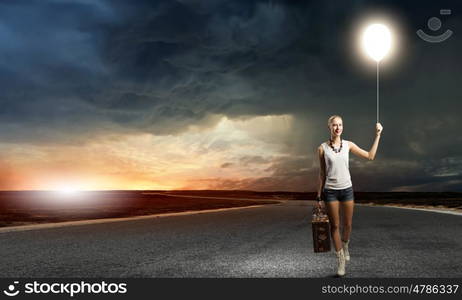 Hiking traveling. Young woman hiker walking with suitcase in hand