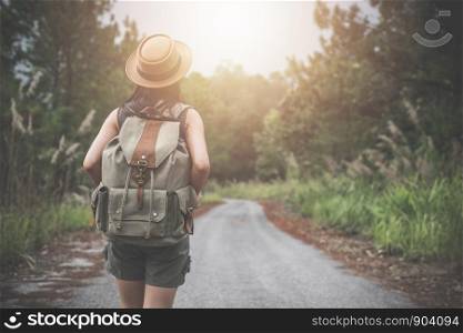 Hiking young woman with backpack watching trekking map, Hiking concept.