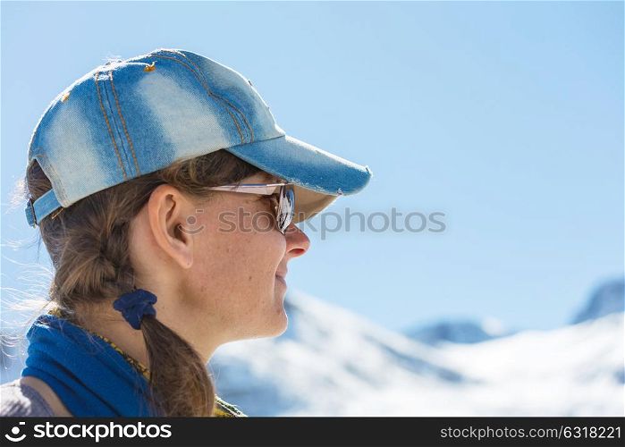 Hiking young woman with winter mountains