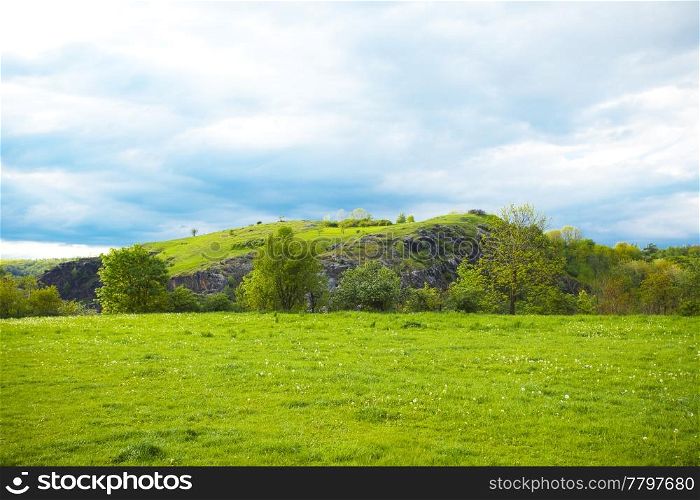 hill on a background of green field